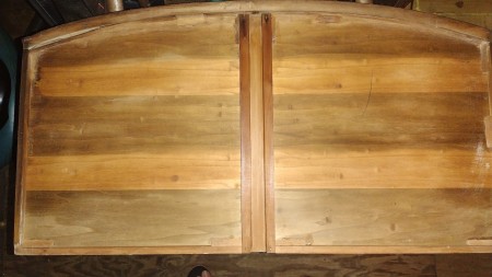 The underside of a wooden drawer.