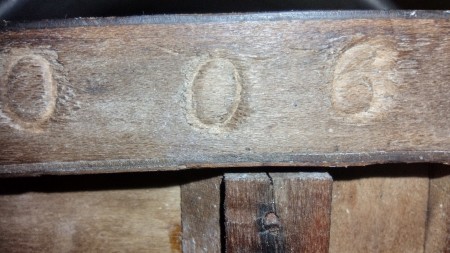Markings on the back of a piece of furniture.