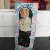 A porcelain nun doll in the box.