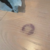 A blue mark on a wooden table.