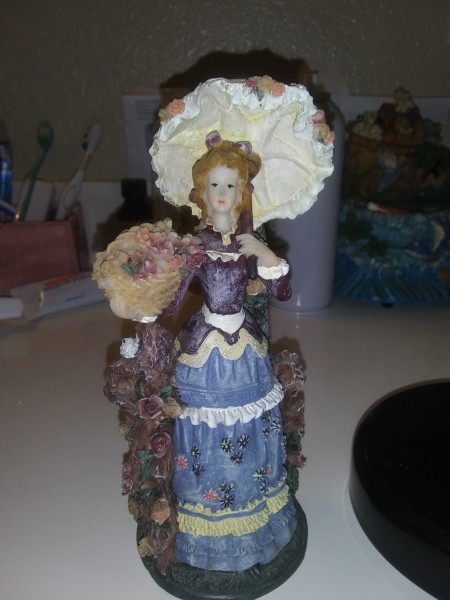 A decorative figurine of a lady.