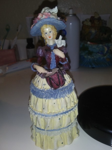 A decorative figurine of a lady.