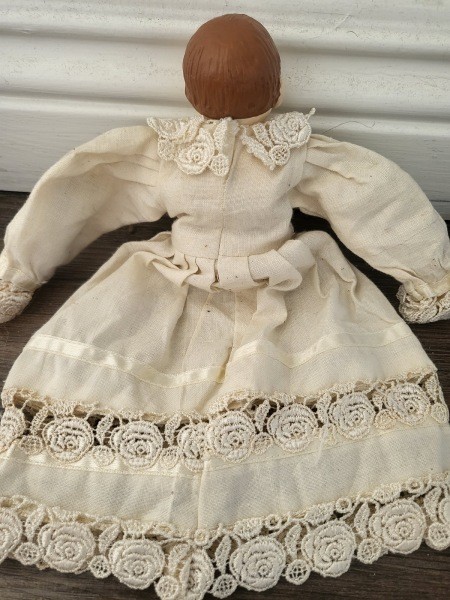 Back view of antique half doll.