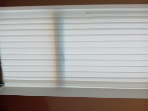 White vertical blinds in a window.