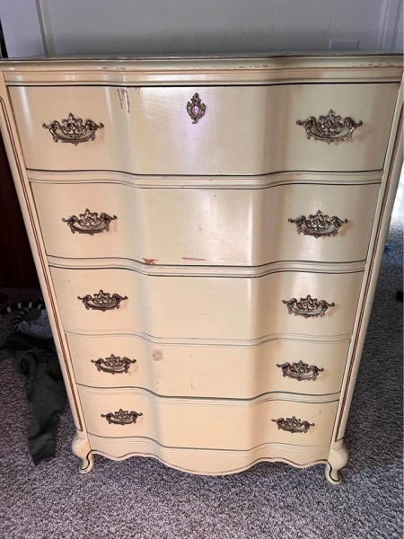 A tall dresser in a cream color.