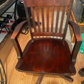 A wooden swivel chair.