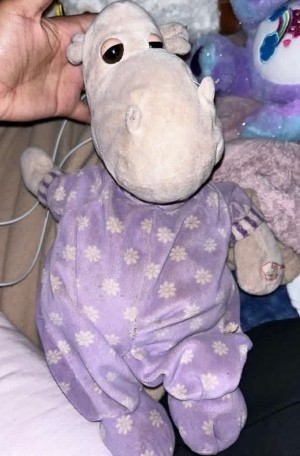A stuffed animal in purple pajamas.