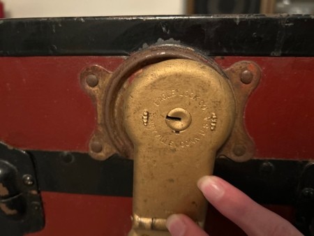 A lock on an old steamer trunk.