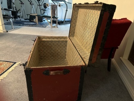 An open steamer trunk.