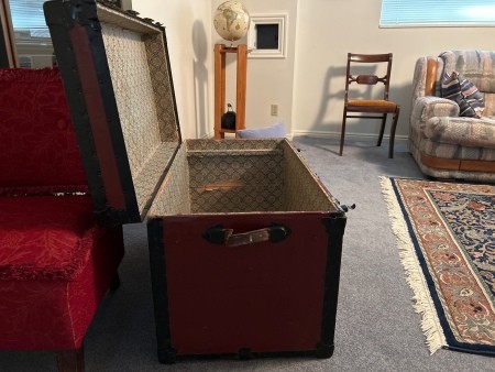 An open steamer trunk.
