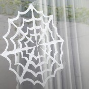 Paper spider web taped to a window.